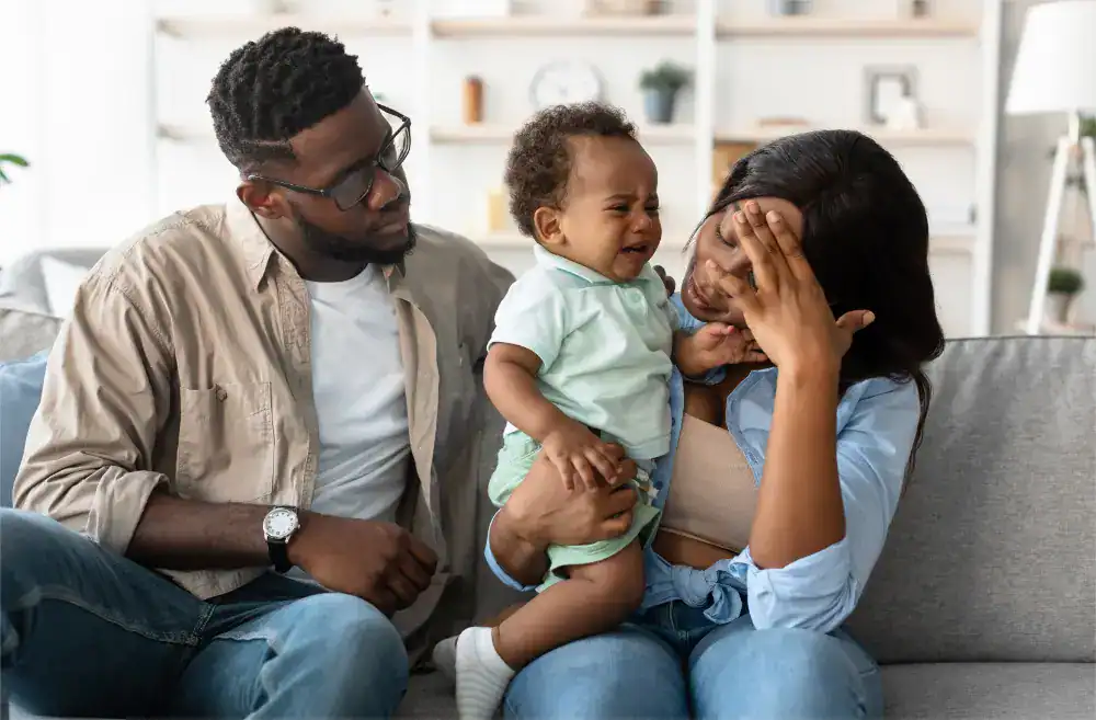 A frustrated toddler reaching toward or reacting to something at eye level on a wall, capturing the universal experience of young children being drawn to objects they shouldn't touch. This image illustrates how repeated exposure to the same stimulus—whether a household item or online advertising—leads to desensitization. For Kenyan businesses, this represents how customers have learned to ignore constant social media ads and promotional messages, making traditional interruption marketing increasingly ineffective in the digital marketplace.